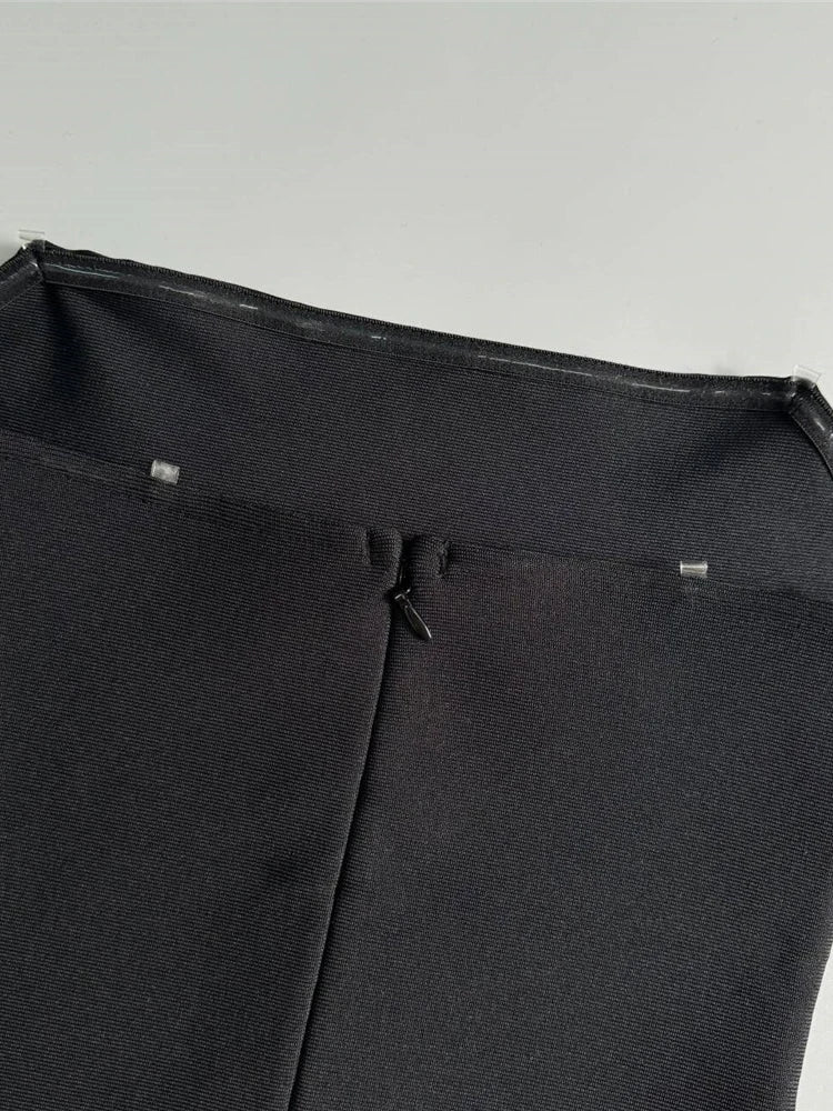 Close-up of a black umbrella with a light gray background