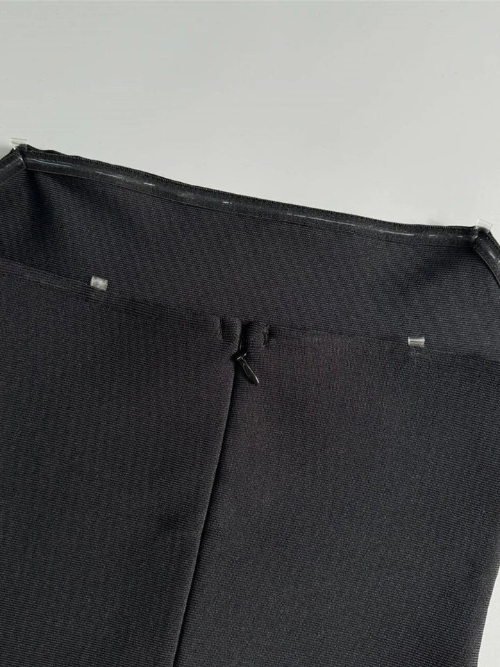 Close-up of a black umbrella with a light gray background