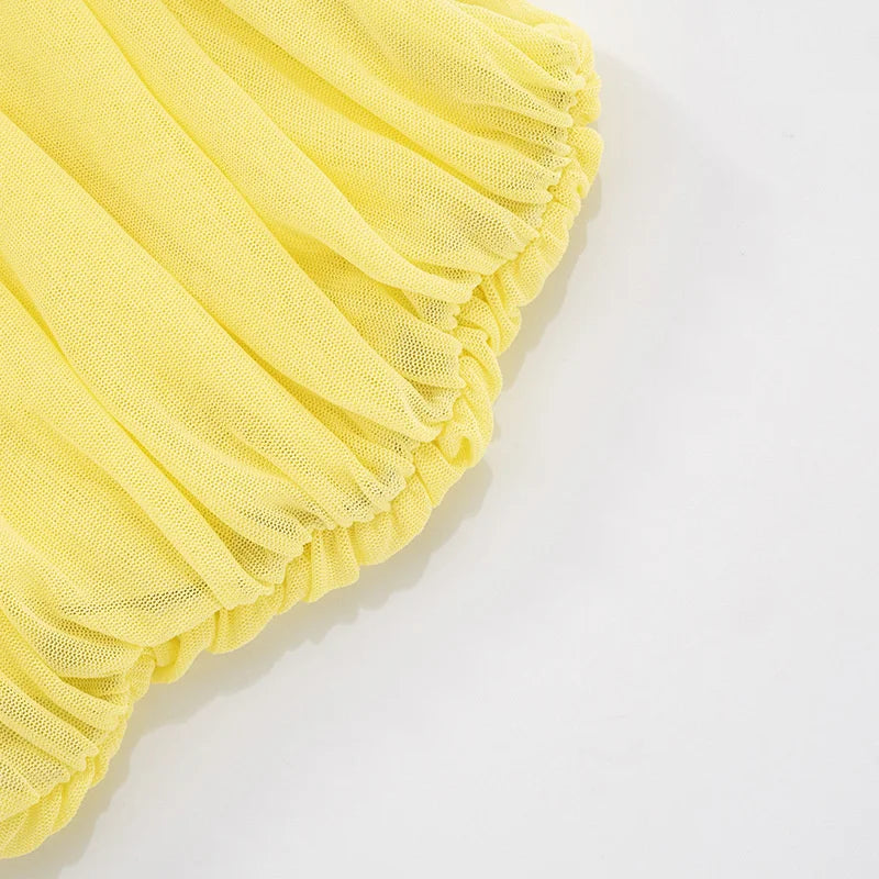 Yellow tulle fabric on a white background