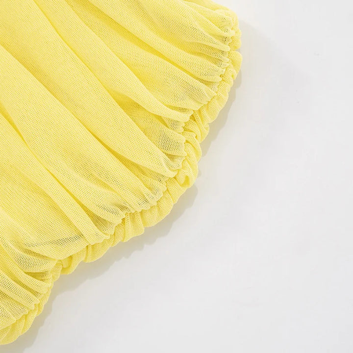 Yellow tulle fabric on a white background