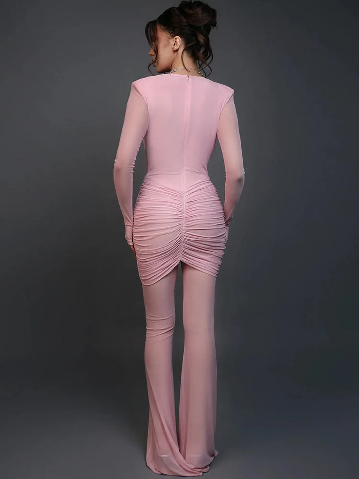 Pink dress with ruched detailing on a dark gray background