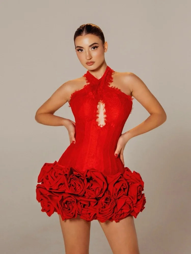 Woman wearing a red dress with floral details against a neutral background