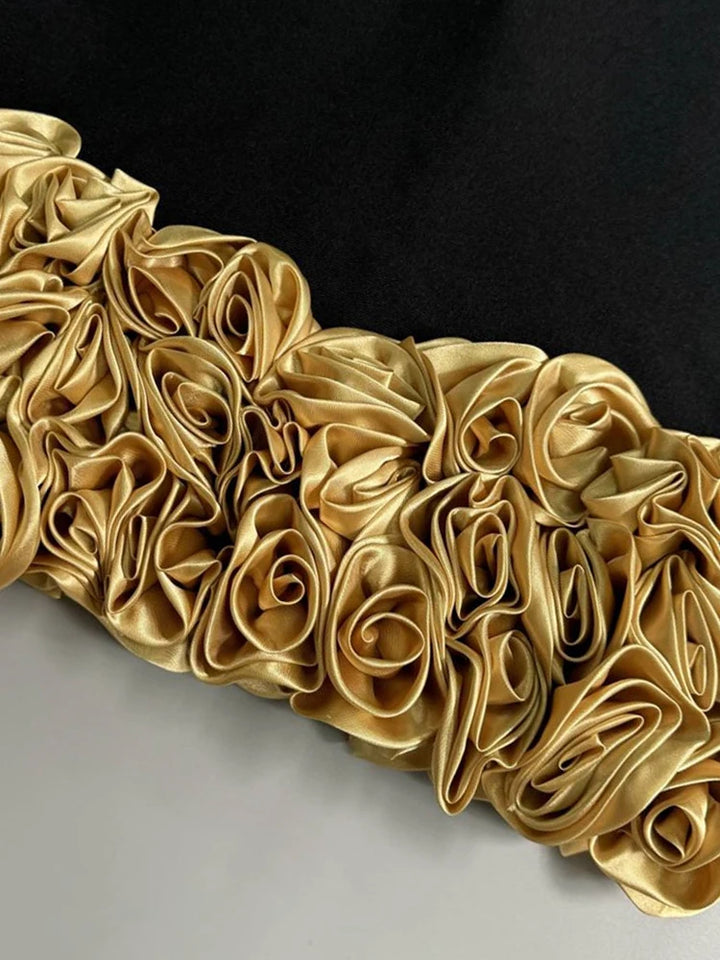 Decorative gold mirror with intricate floral patterns on a black background