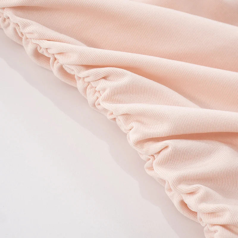Close-up of light pink fabric with a soft texture on a white background