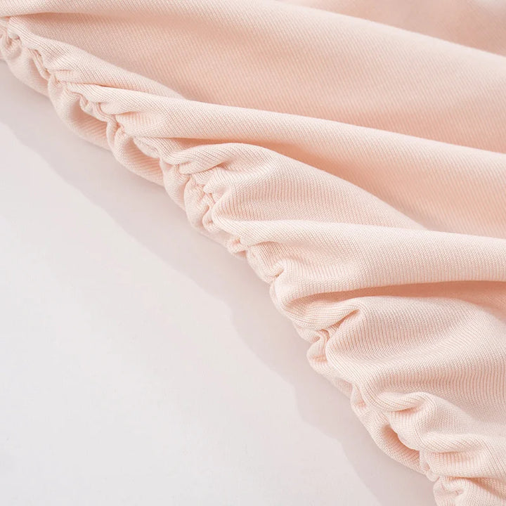 Close-up of light pink fabric with a soft texture on a white background