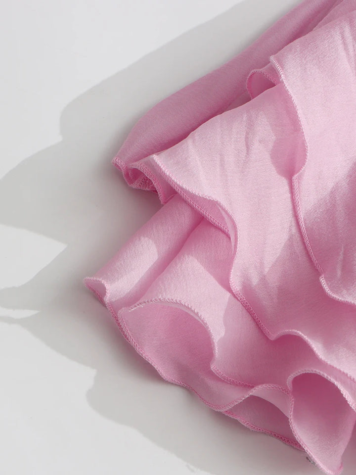 Close-up of pink fabric with ruffled edges on a white background