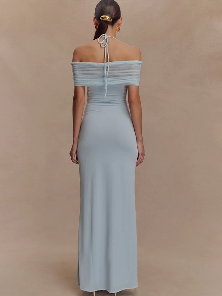 Woman wearing a light blue off-shoulder gown against a beige background