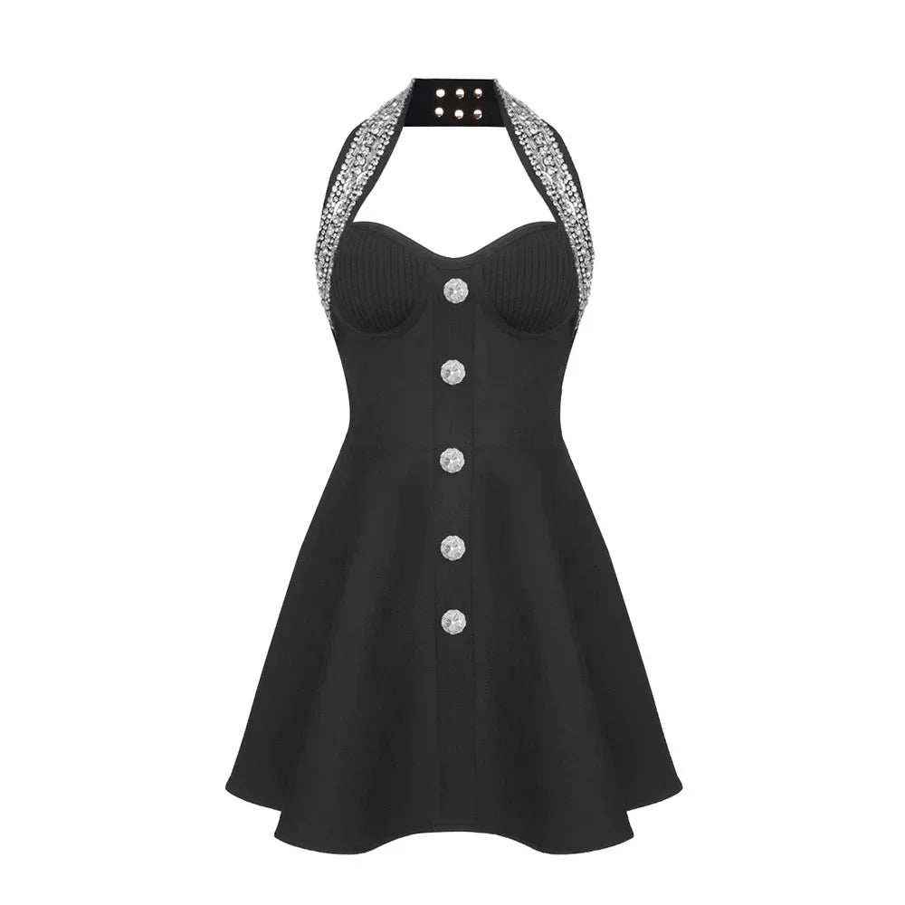 Black dress with silver buttons and embellished straps on a white background