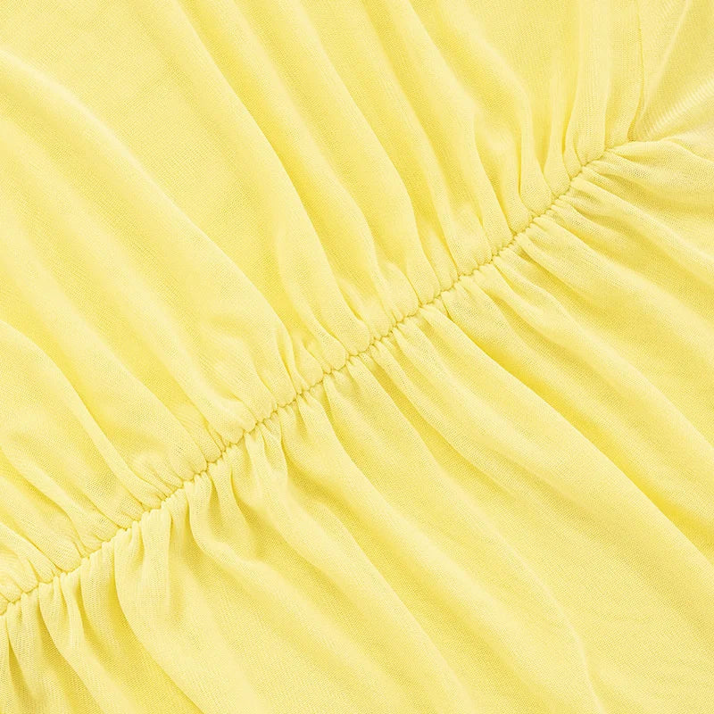 Close-up of yellow fabric with a focus on texture and stitching.