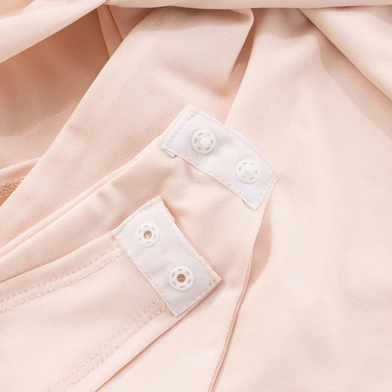 Close-up of a light pink fabric with white buttons on a matching fabric background