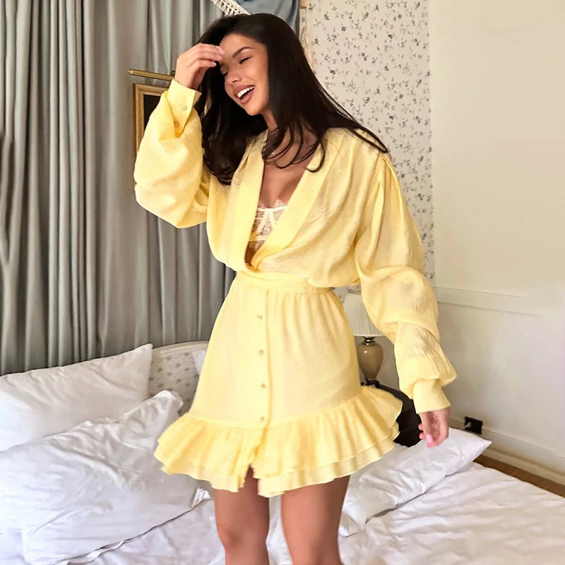 Woman in a yellow dress standing in a bedroom