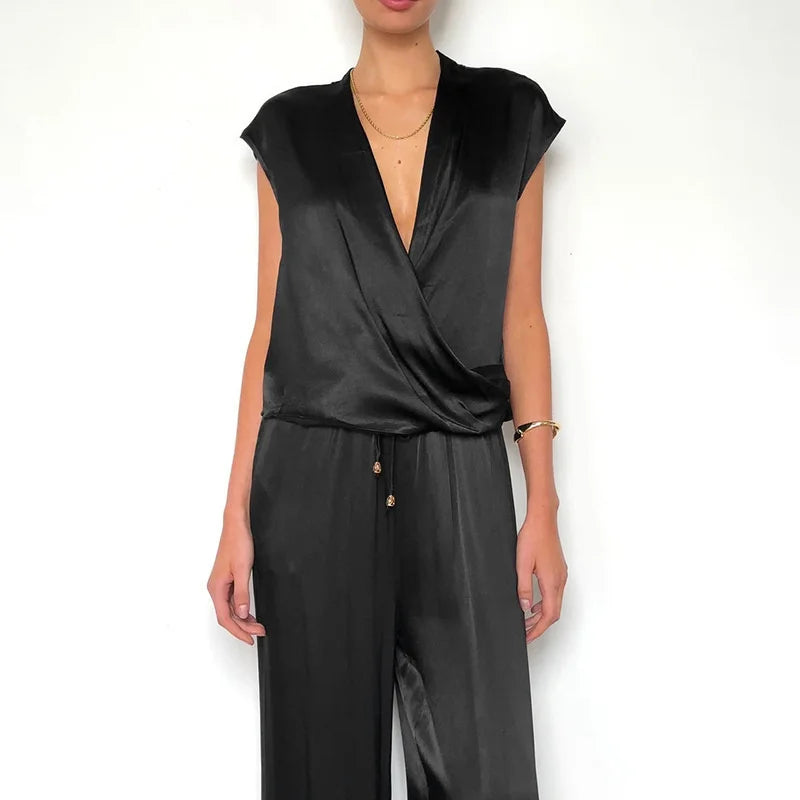 Black jumpsuit worn by a model on a white background