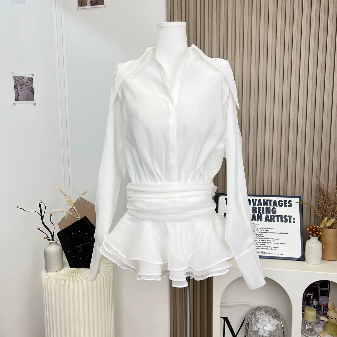 White shirt and skirt set on a mannequin in a room.