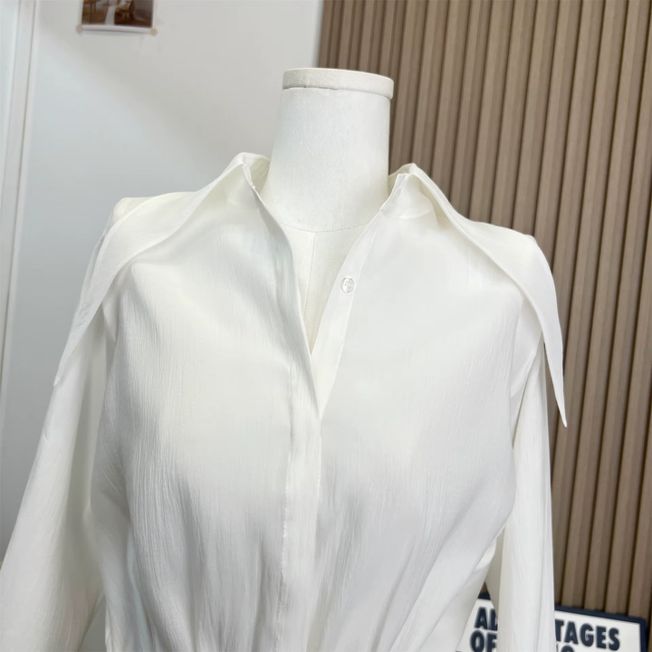 White shirt on a mannequin against a neutral background