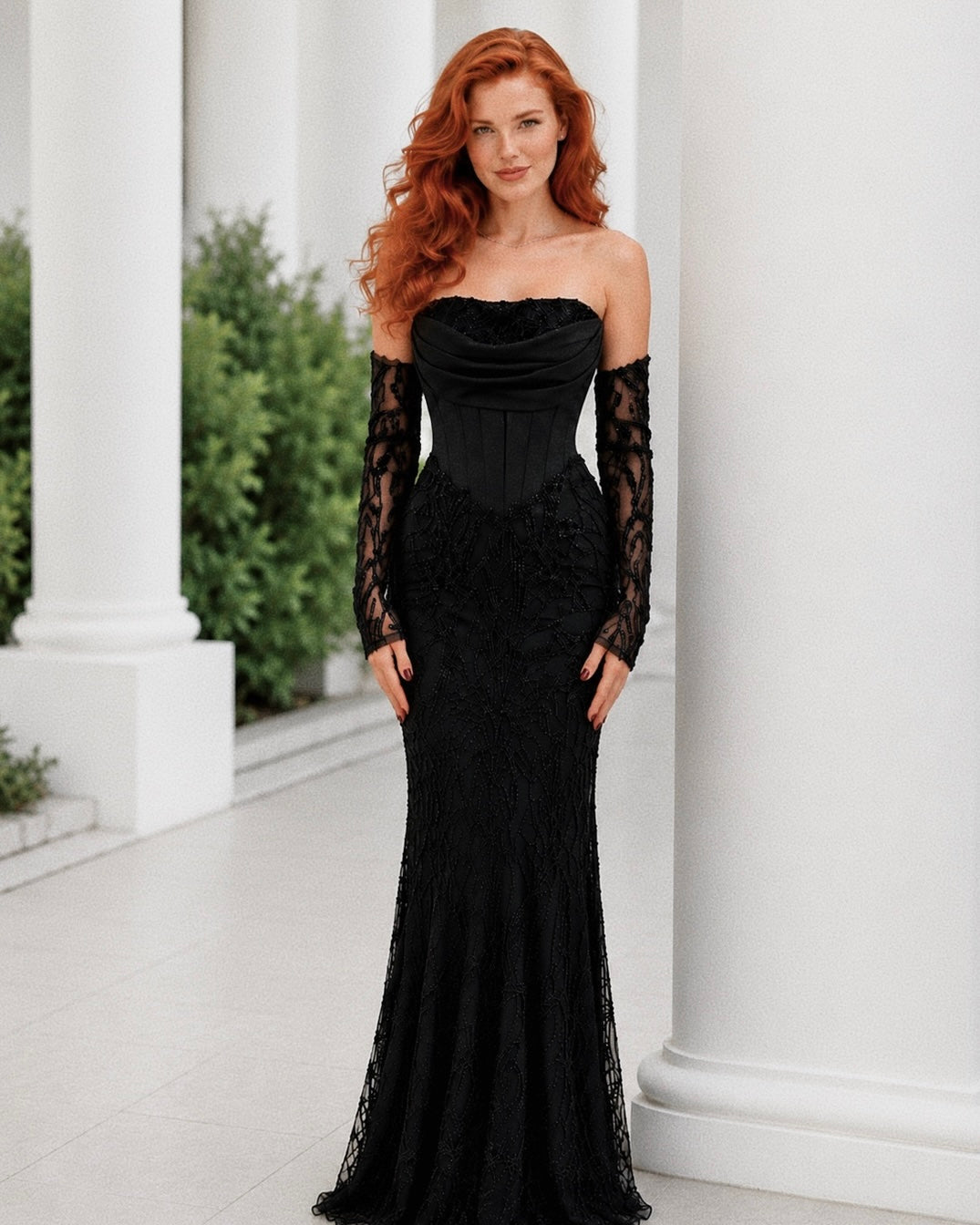 Woman wearing a black lace dress with long sleeves in an outdoor setting.