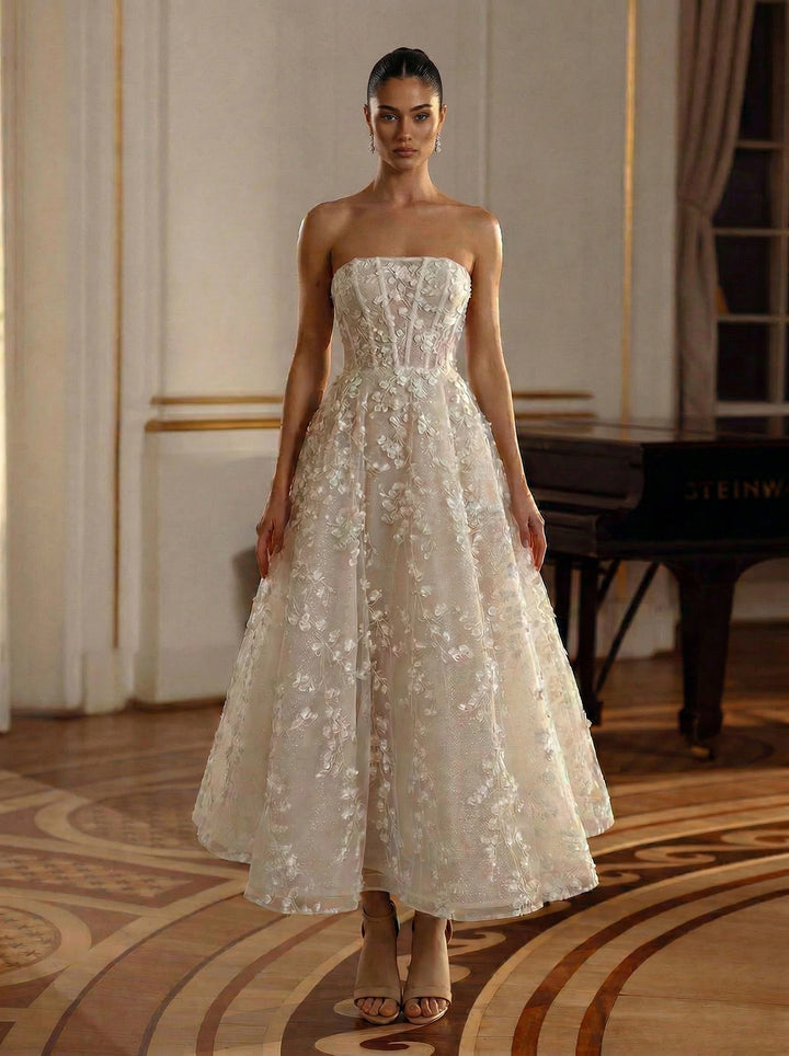 Woman wearing a strapless floral dress in an elegant room.