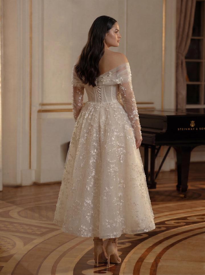 Woman in a white sequin dress standing in an elegant room with a piano.