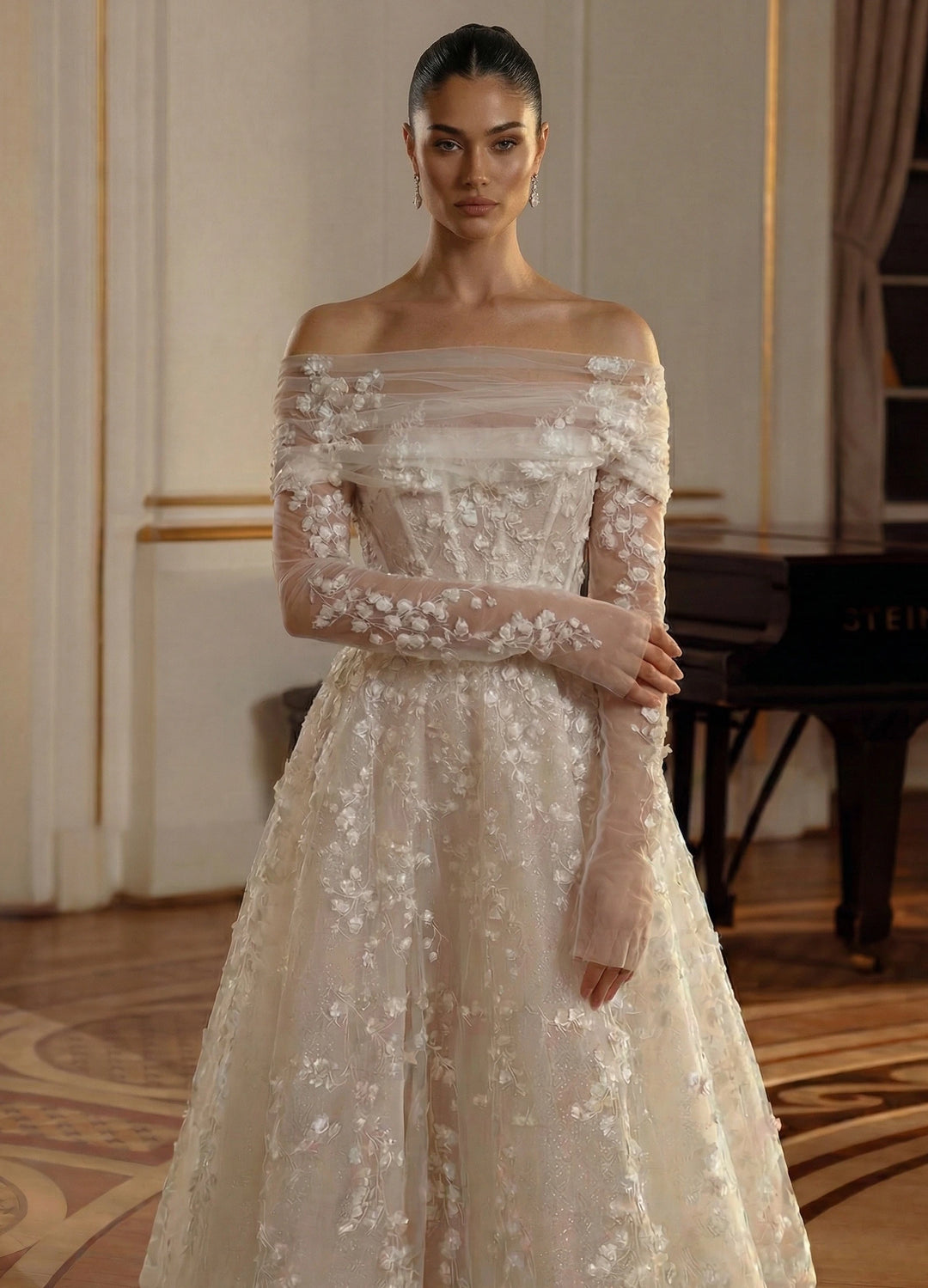 Woman wearing a beige off-shoulder gown with floral details in an elegant room.