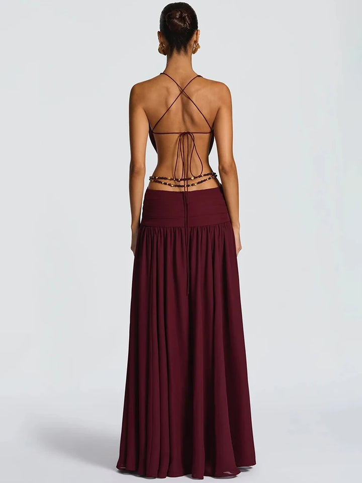 Burgundy evening gown with open back on a white background