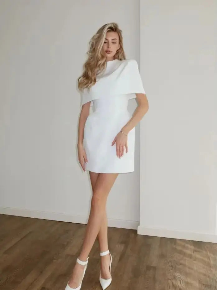 Woman wearing a white dress against a plain background