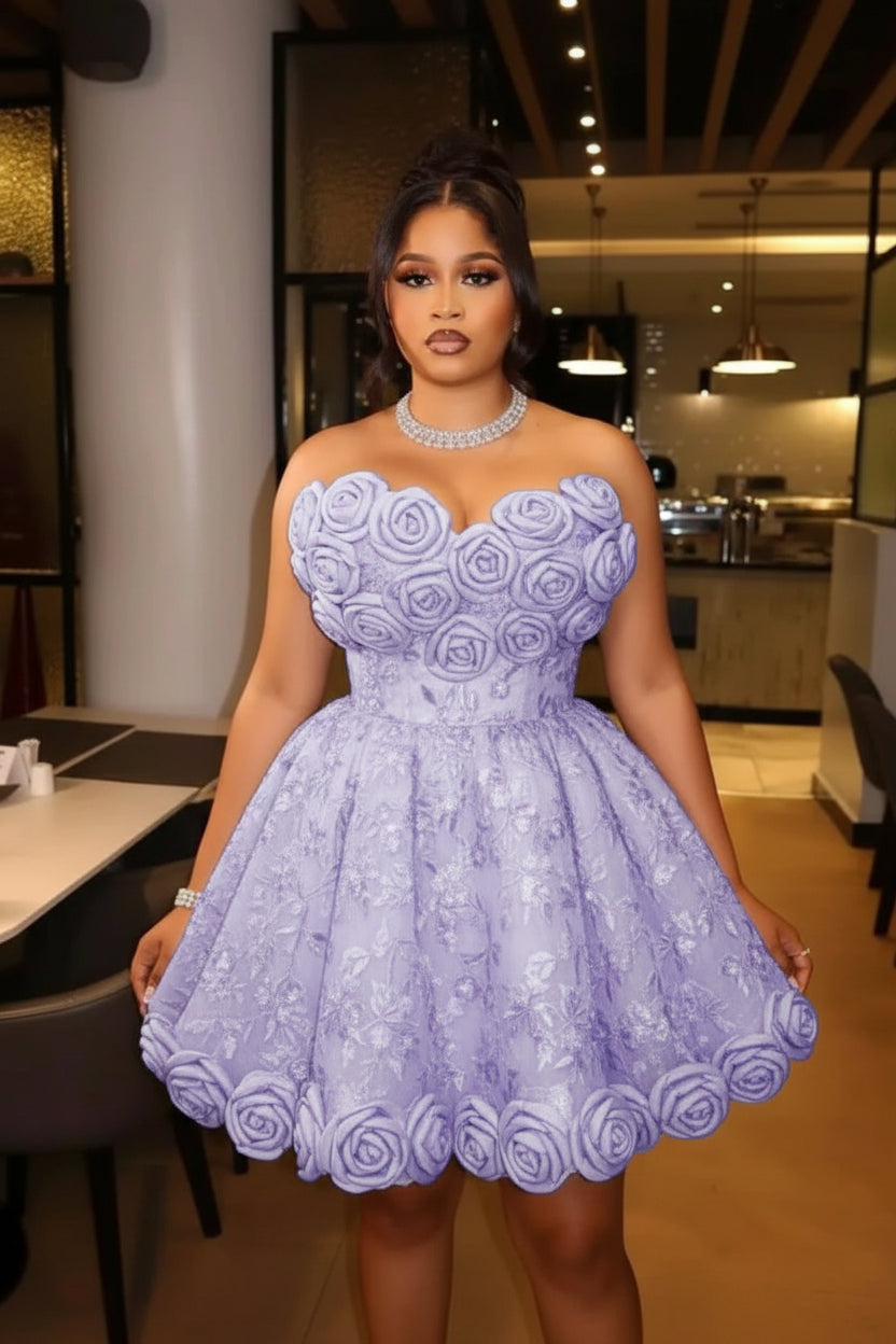 A woman wearing a strapless lavender lace dress with 3D rose applique and a flared skirt, standing in an indoor restaurant or event space.