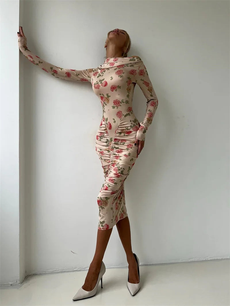 Person wearing a floral dress against a white wall