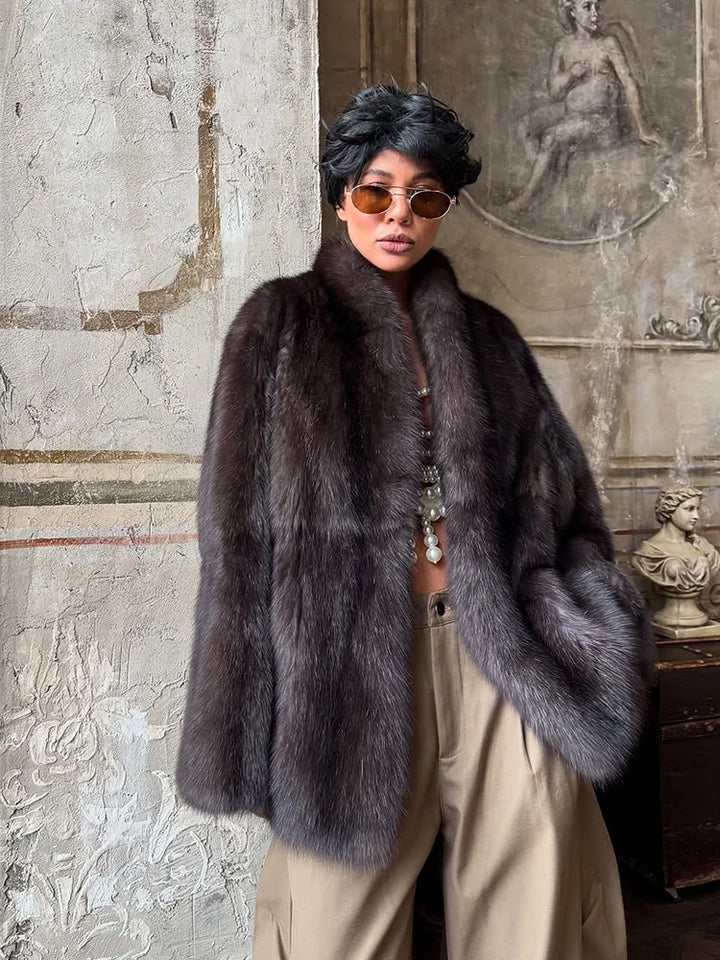 Person wearing a fur coat in an artistic setting