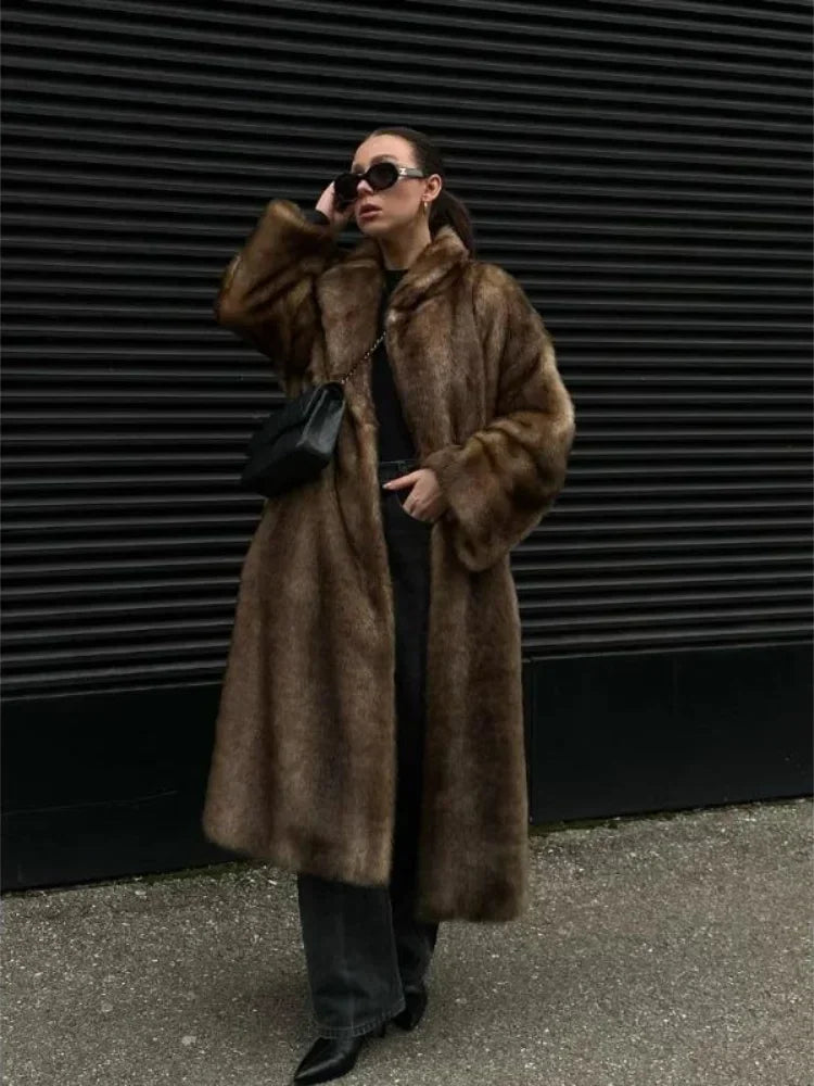 Person wearing a brown fur coat against a dark background