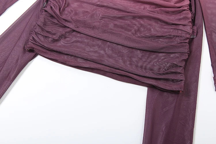Close-up of a purple garment with ruffled details on a white background