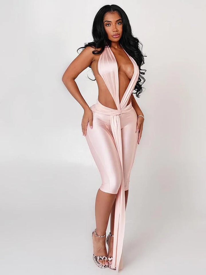 Woman wearing a pink jumpsuit with a white background