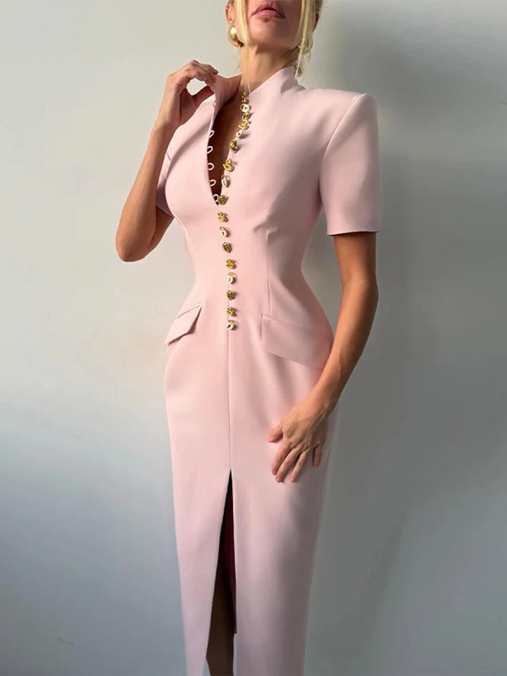 Pink dress with gold buttons on a plain background