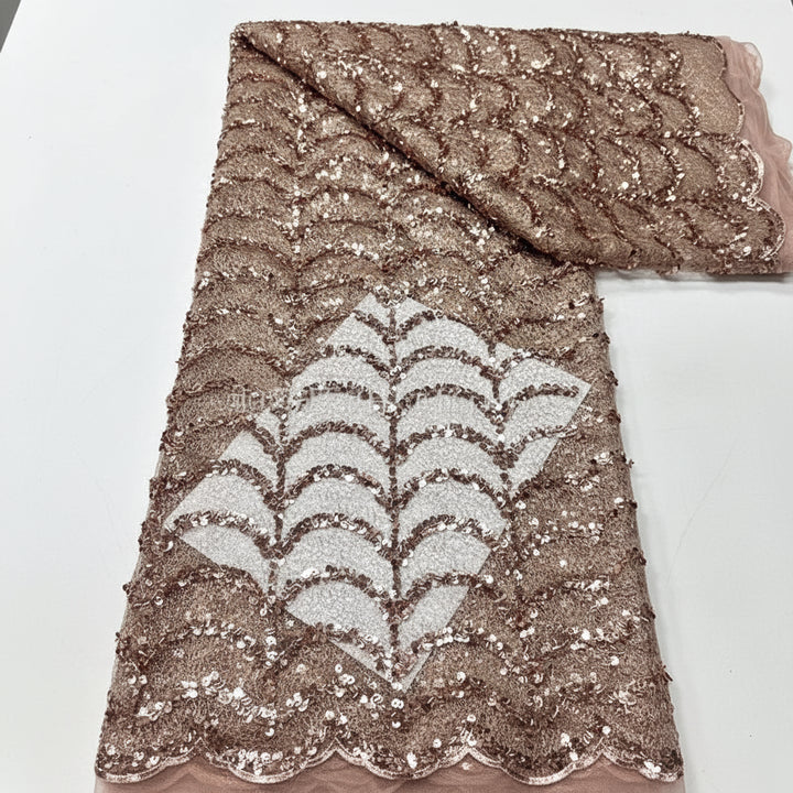 Close-up of a textured fabric with a leaf pattern on a white background