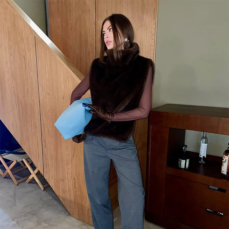 Woman holding a blue bag in a modern interior setting