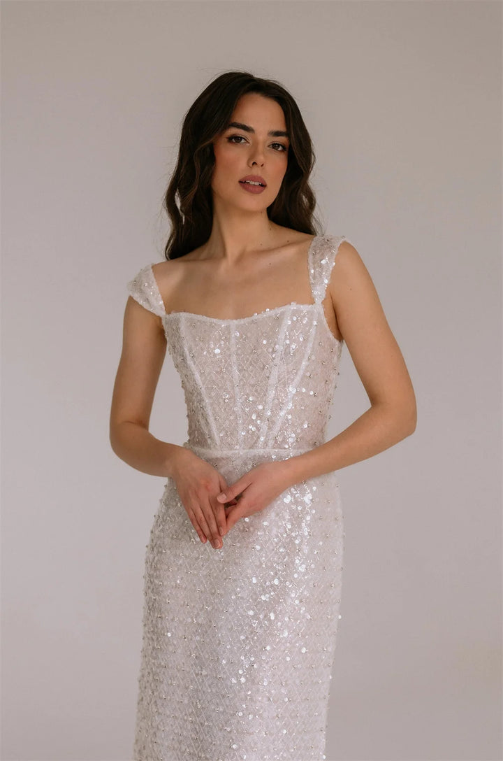 Maxi Dress epitomizes bridal elegance with its lustrous ivory sequin embellishment and refined silhouette