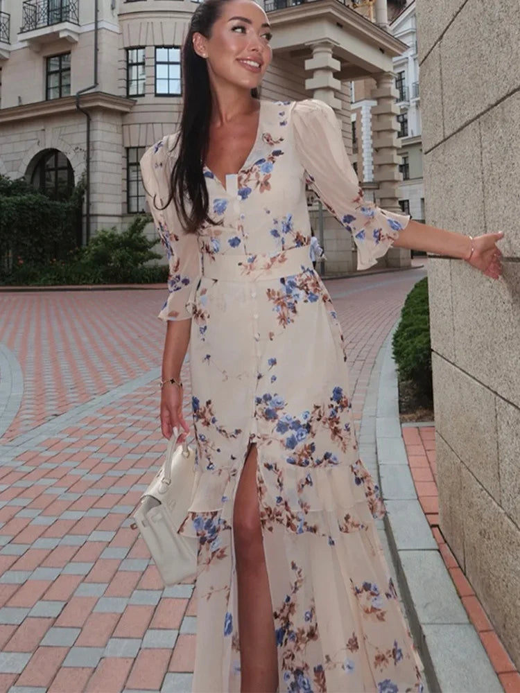 Woman in a floral dress standing on a city street