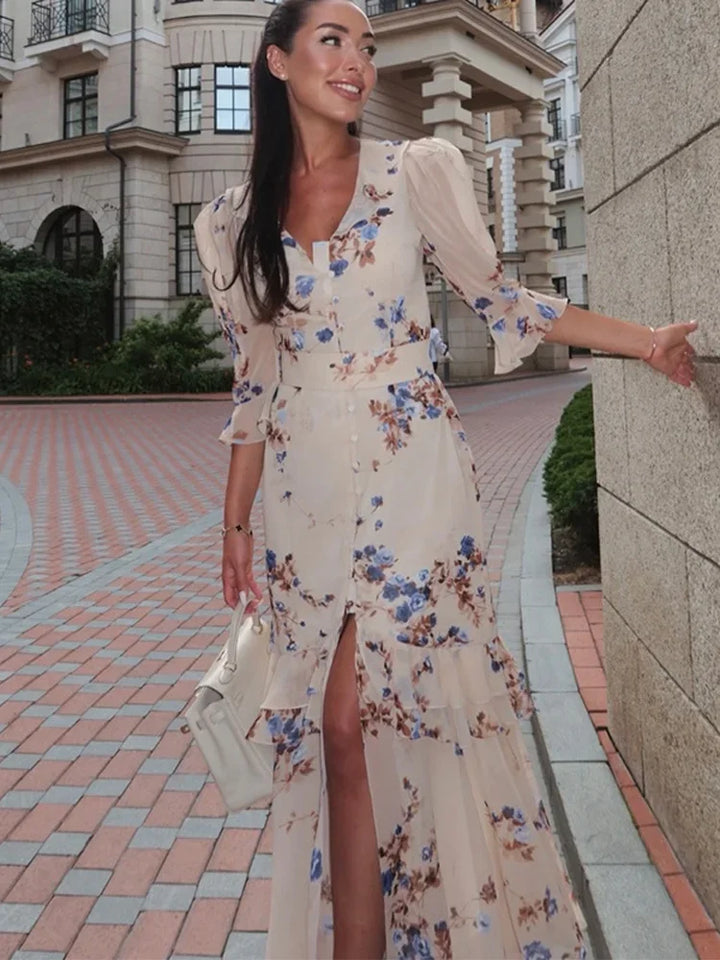 Woman in a floral dress standing on a city street