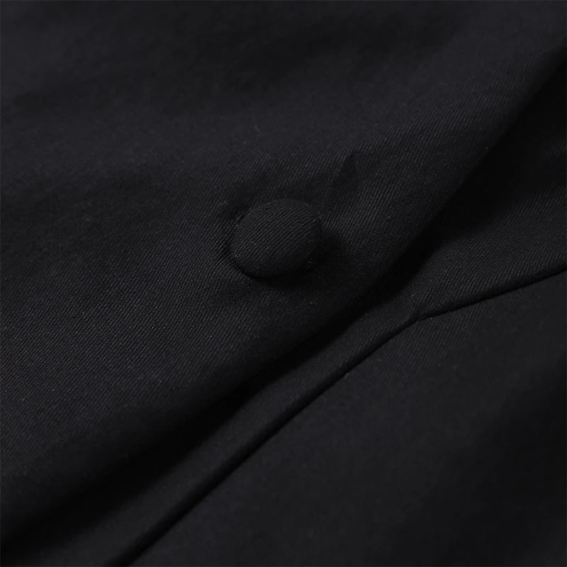 Close-up of a black button on fabric