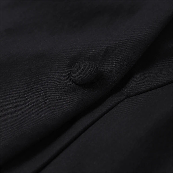 Close-up of a black button on fabric