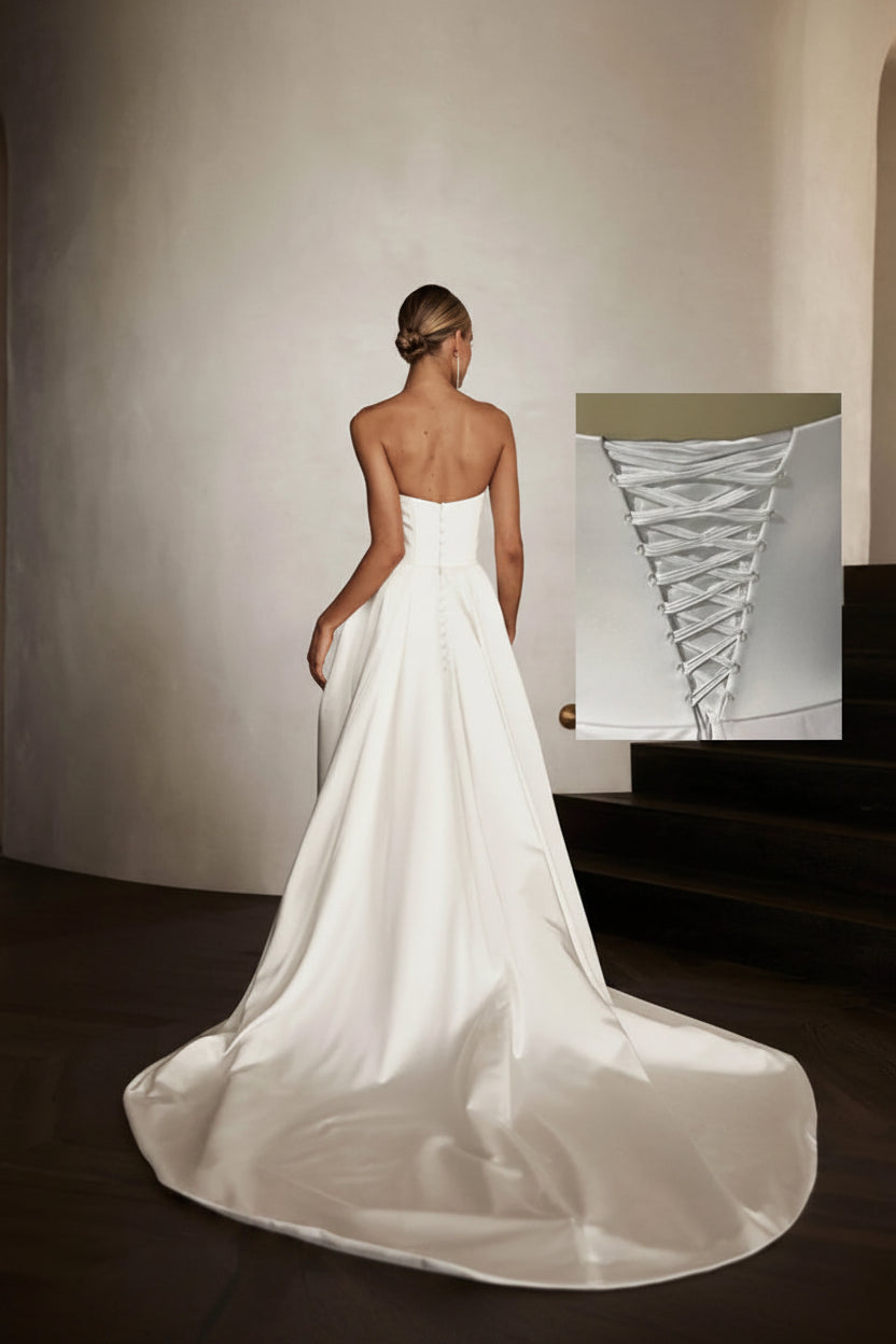 White wedding dress with a close-up inset of lace detail on a neutral background