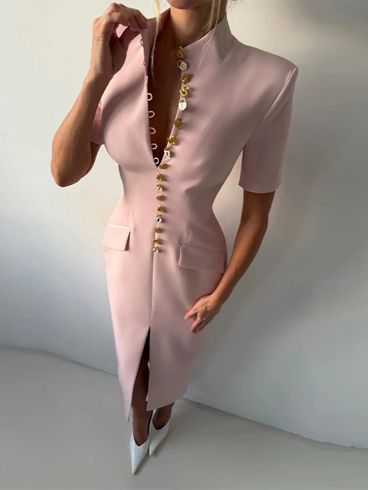 Pink dress with gold buttons on a plain background