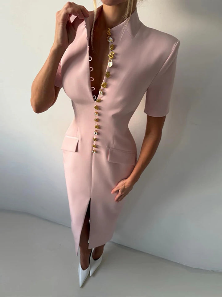 Pink dress with gold buttons on a plain background