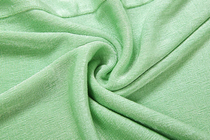 Close-up of green fabric with folds