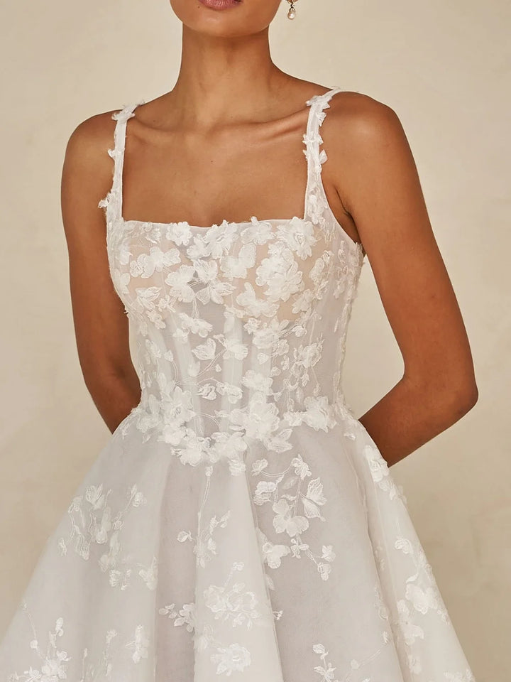 White lace dress with thin straps on a neutral background