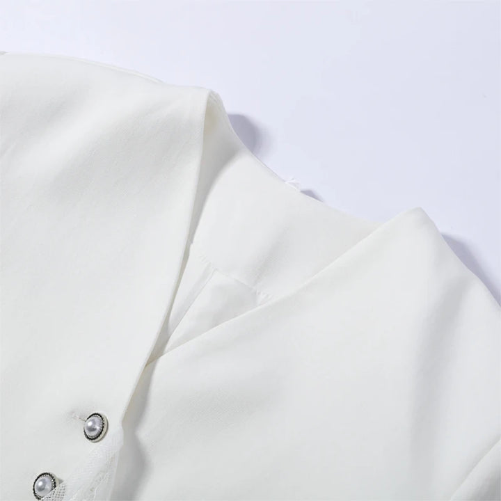 Close-up of a white blouse with buttons on a light gray background