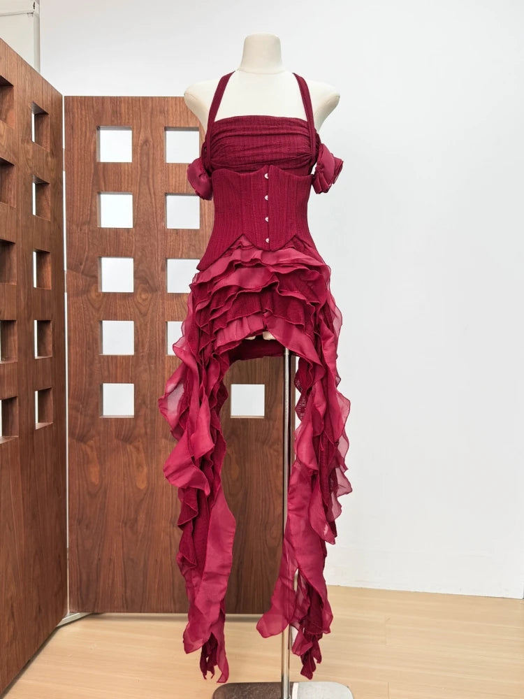 Red ruffled dress on a mannequin against a wooden panel background