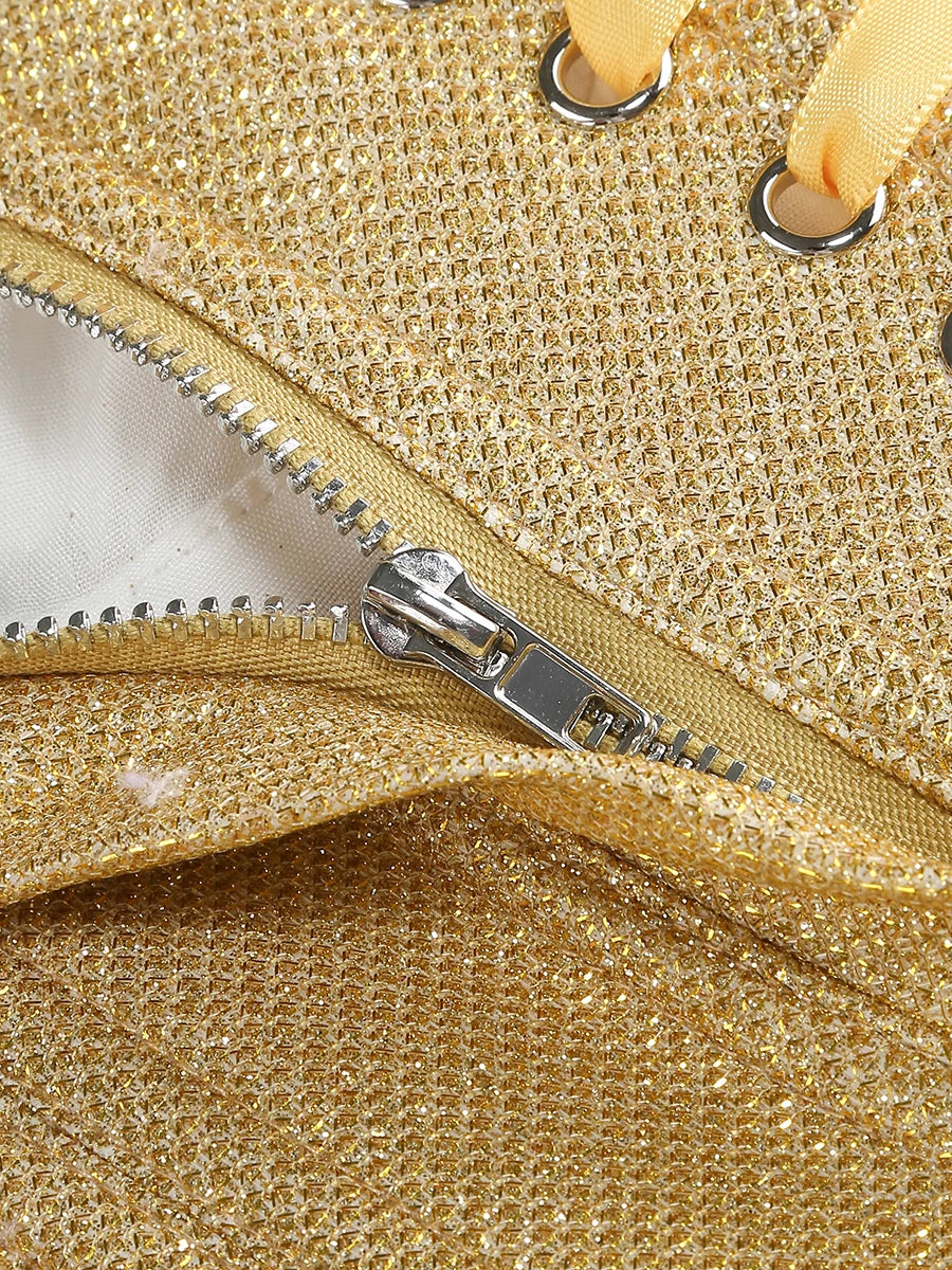 Gold mini dress with ruffled bottom on a white background