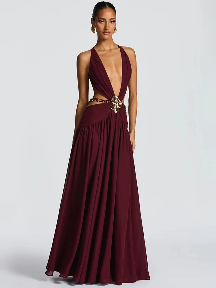 Maroon evening gown with a deep neckline and embellishments on a white background