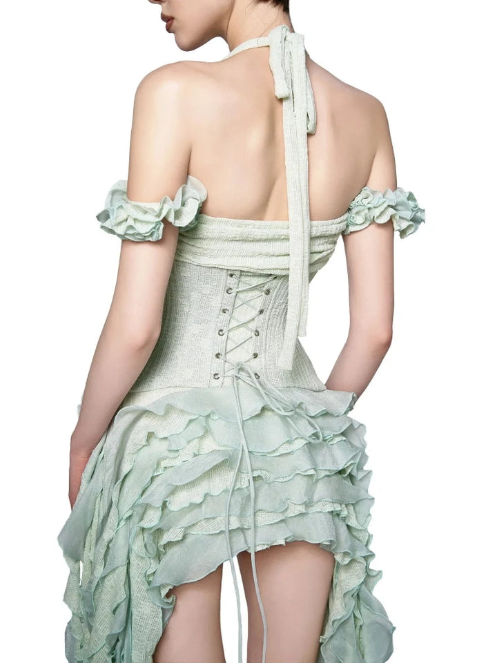 Light green dress with ruffled details on a white background