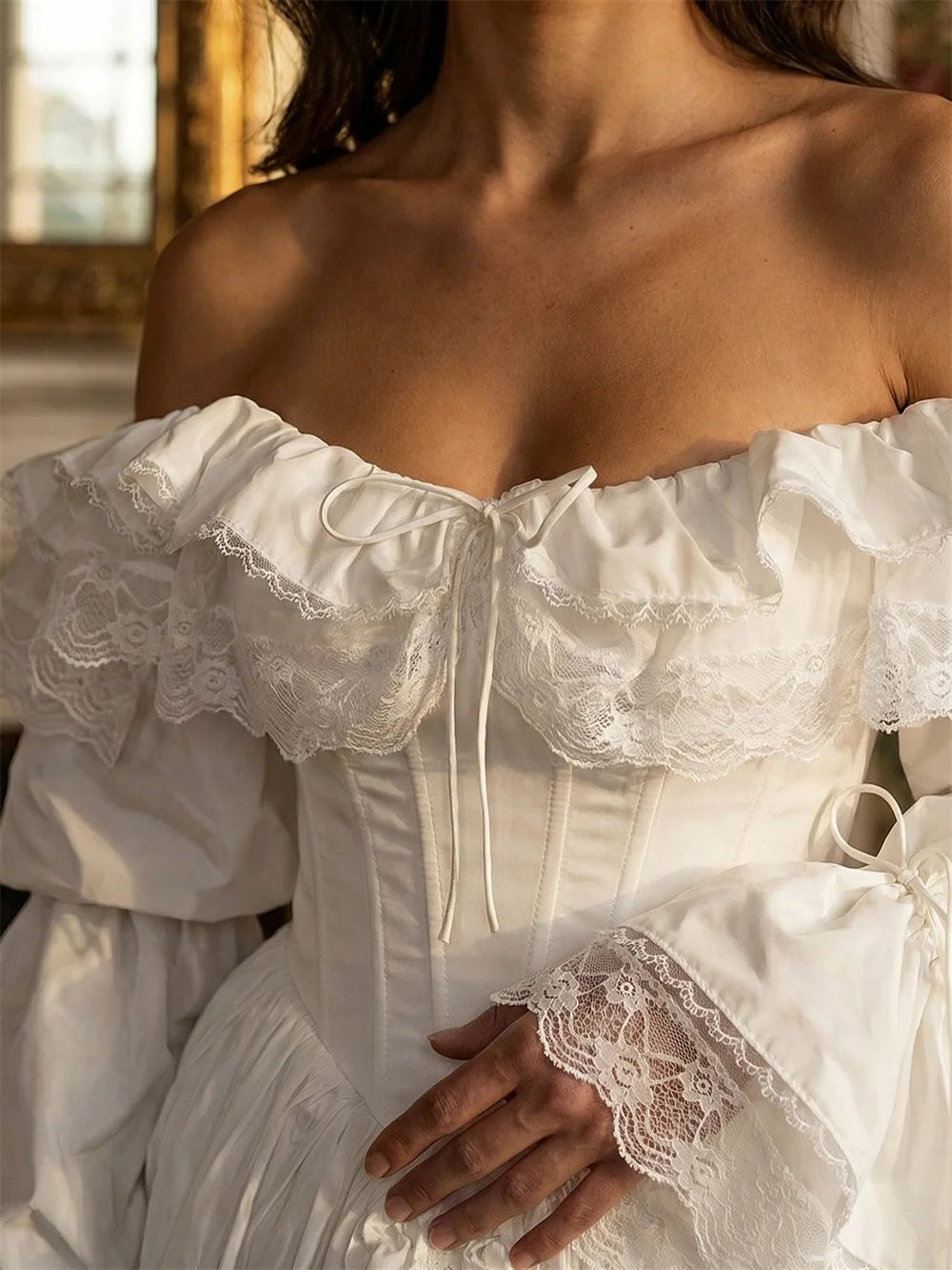 Close-up of a white lace dress with a blurred background