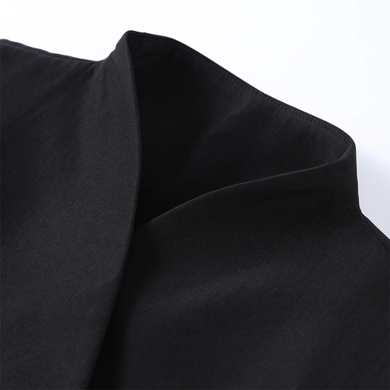 Close-up of black fabric with a subtle texture on a white background
